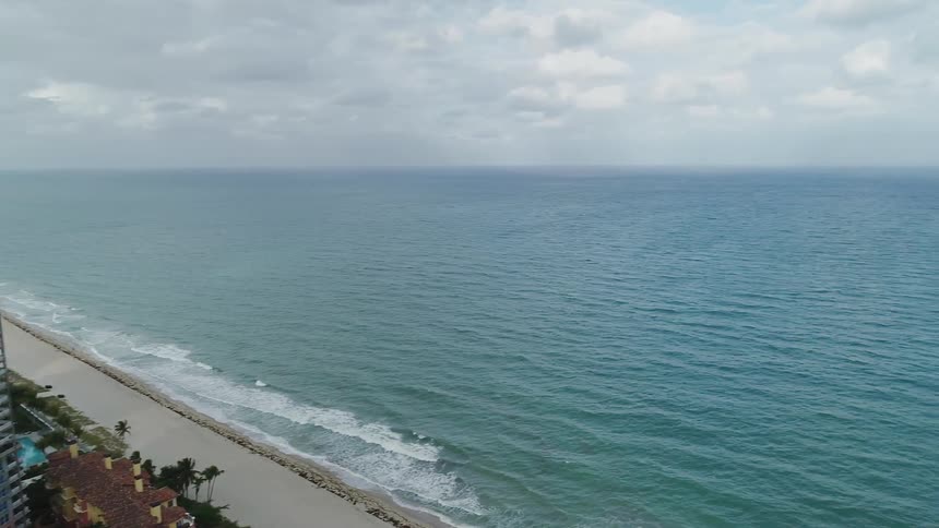 The tide flows onto the beach shore