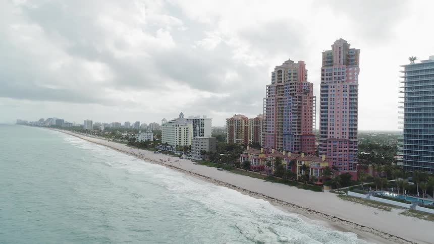 The tall buildings are right against the sand