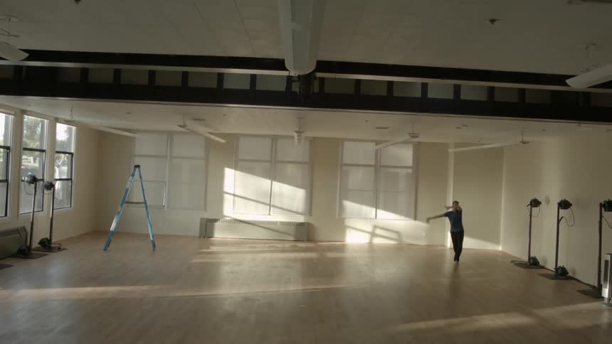 A man dances in an empty studio