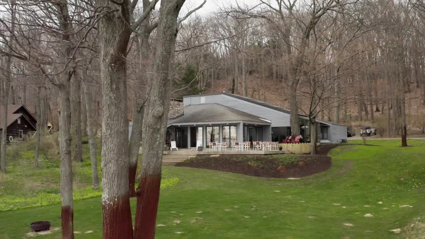 The house is surrounded by large trees