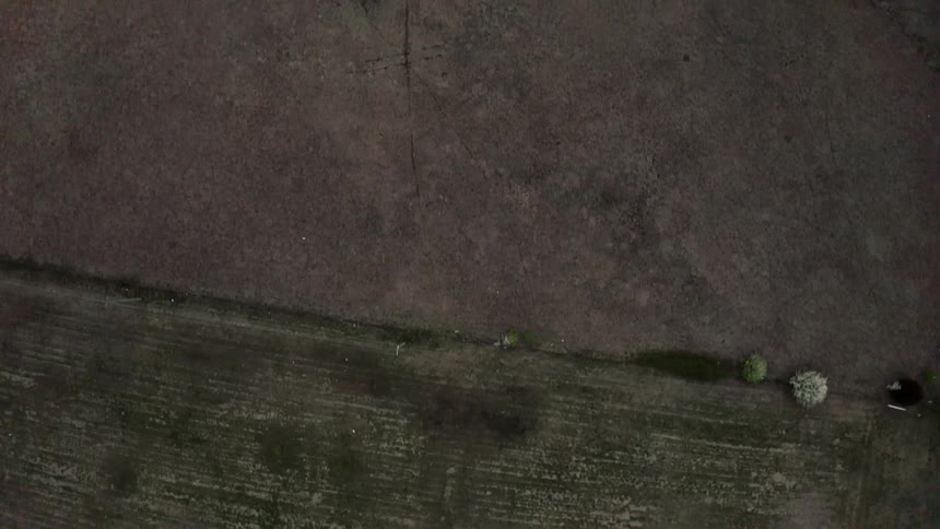The long fields below are barren