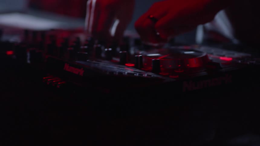 A person is turning knobs on the turntable