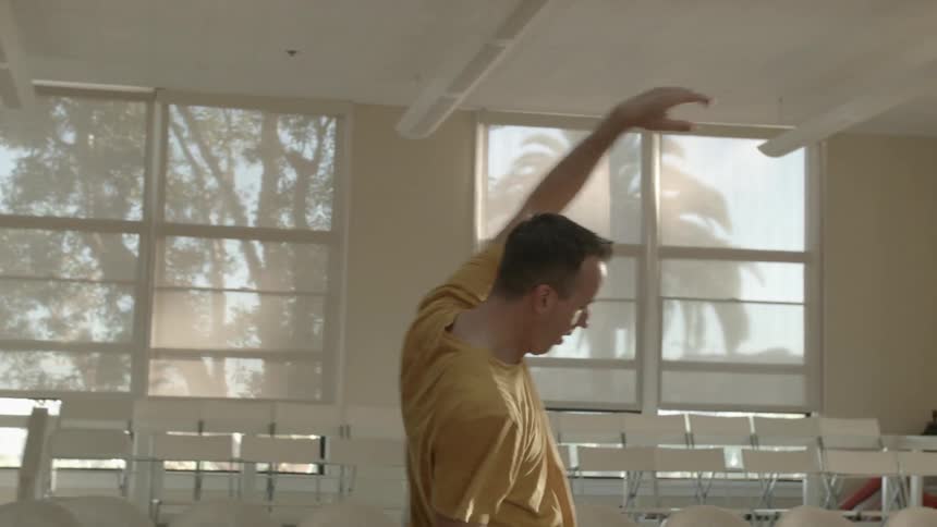 A man dancing in a sunlight studio