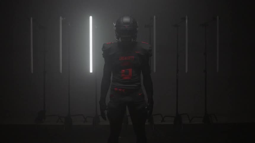 Silhouette of a person standing in a dark room with flashing lights