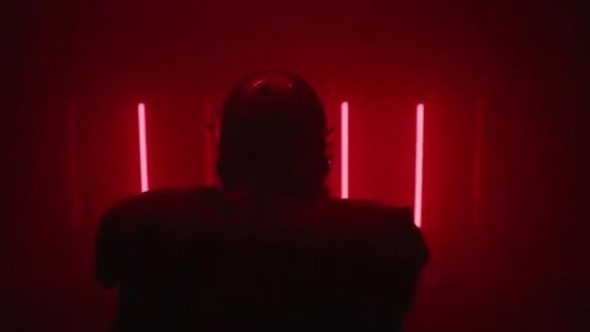 Red lights flash around a football player