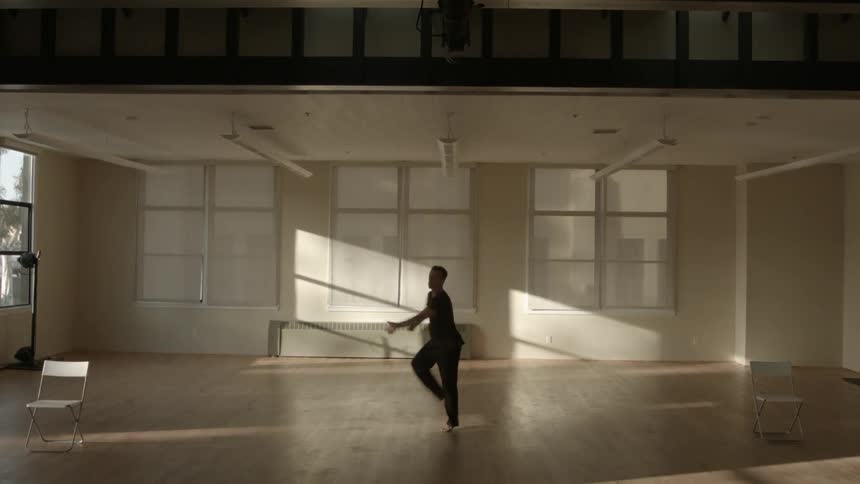 A man dances in an empty studio