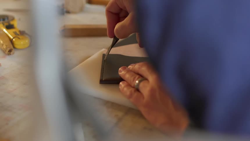 The man is tracing something he is working on