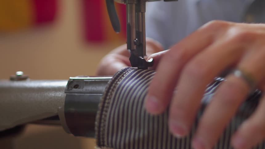 A man uses a sewing machine