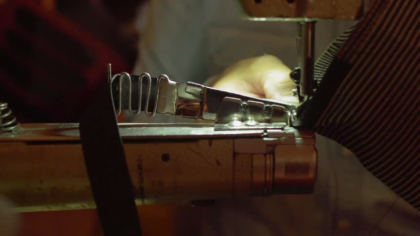 A person uses a sewing machine