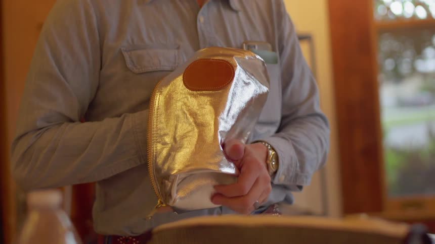 A man is opening up a pocket book