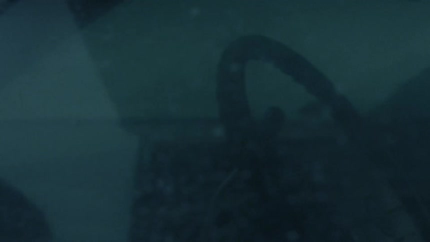 A person sits in a snow covered car
