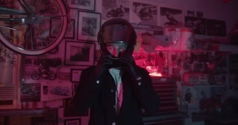 Man puts on a helmet and pulls down the visor