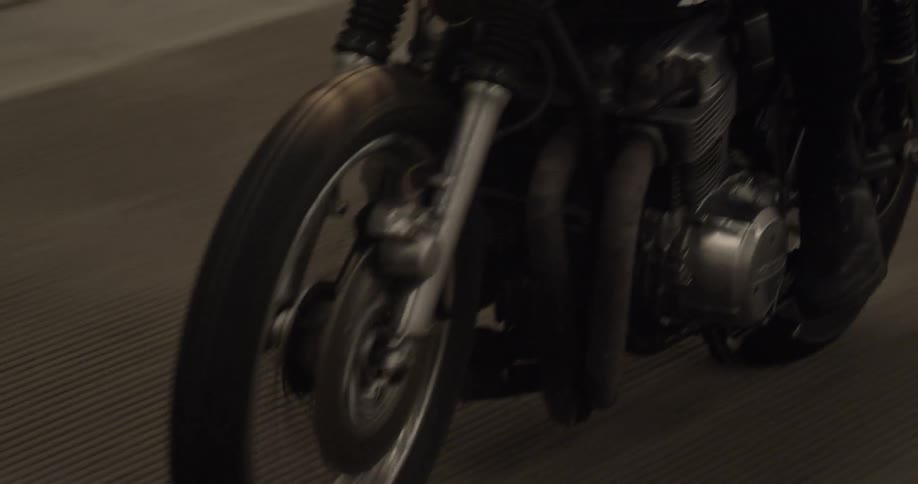 The motorcycle is riding with the headlamp on
