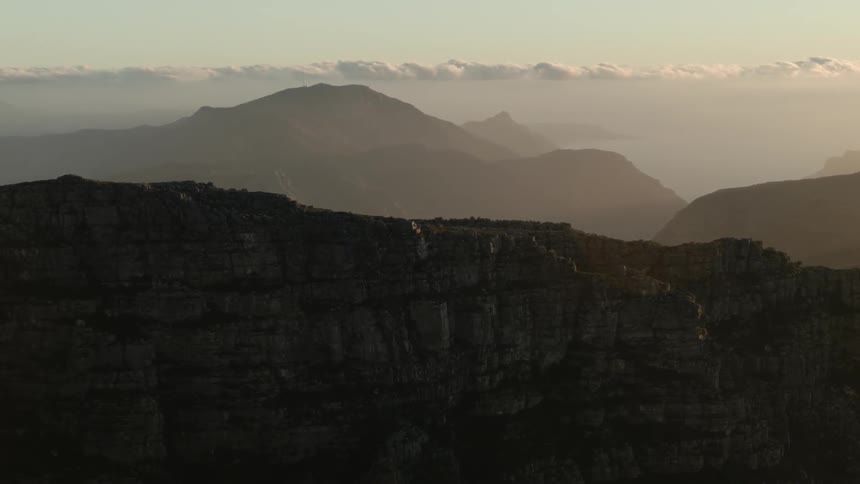 Clouds float over mountains in the distance