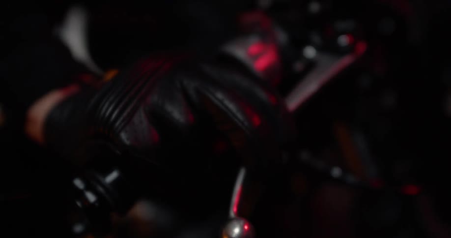 A person is wearing leather gloves on the motorcycle