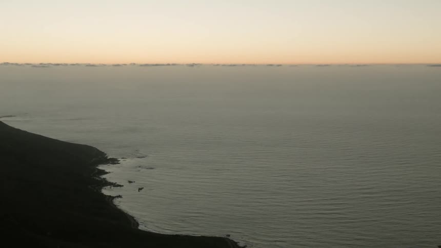 A shoreline at sunset or sunrise