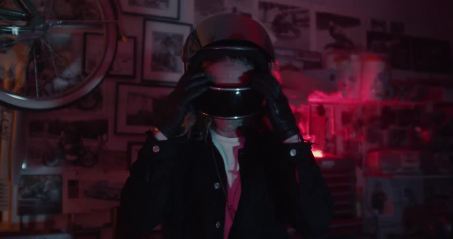 A man puts on a motorcycle helmet