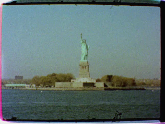 The statue of liberty towers in the distance
