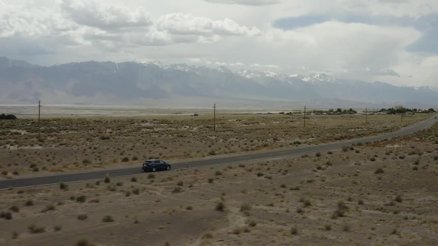 A car drives on a rural road