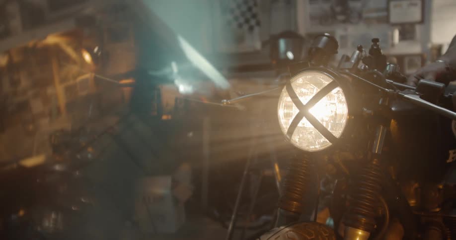 Man Working On Motorcycle In Garage