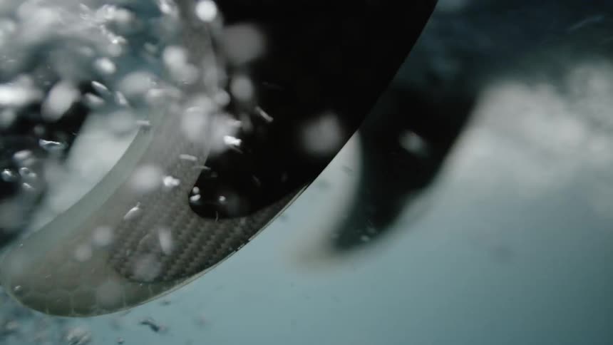 Bubbles float beneath a surfboard