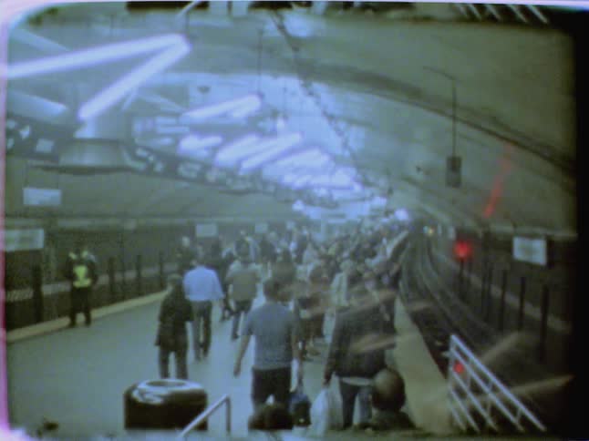 People walking through a crowded train terminal