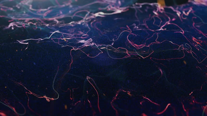 Ribbons of white and pink float and wave in blue liquid
