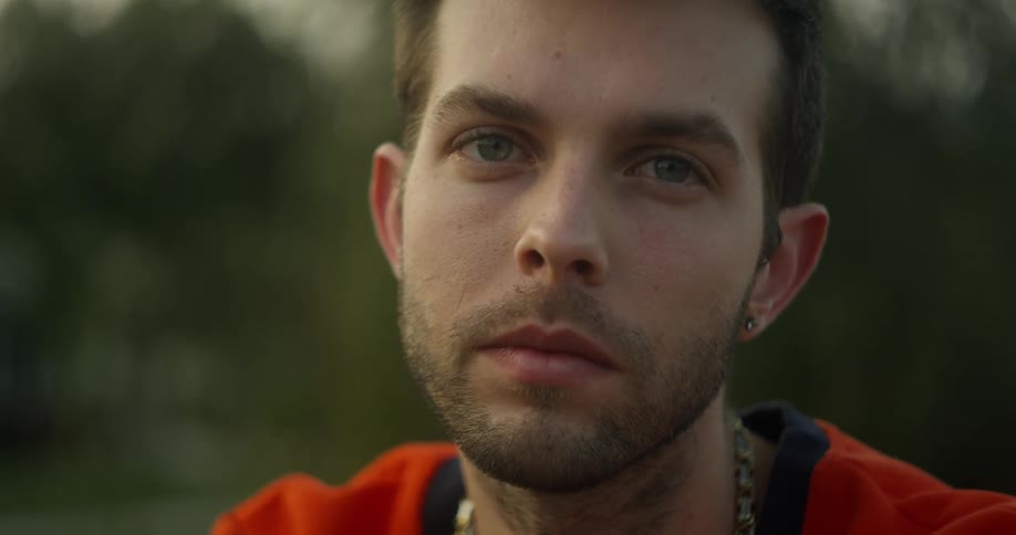 A young man stares forward