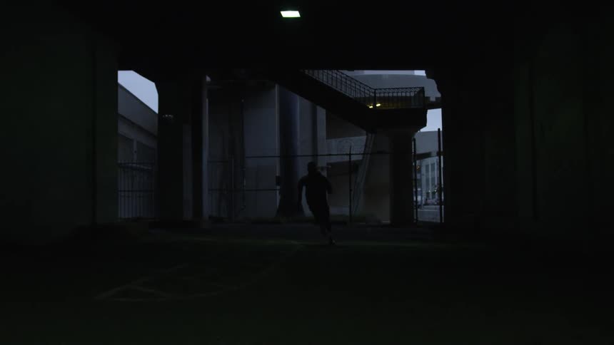 Man runs through the pillars in the dark