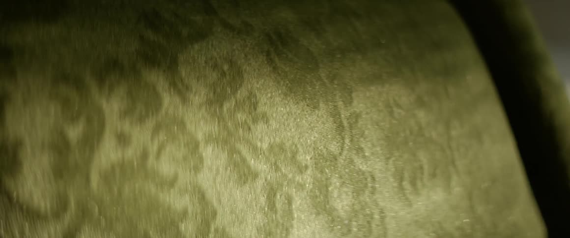 Glimmering evening sunlight on green fabric