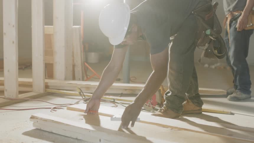 Construction workers work with the lumber