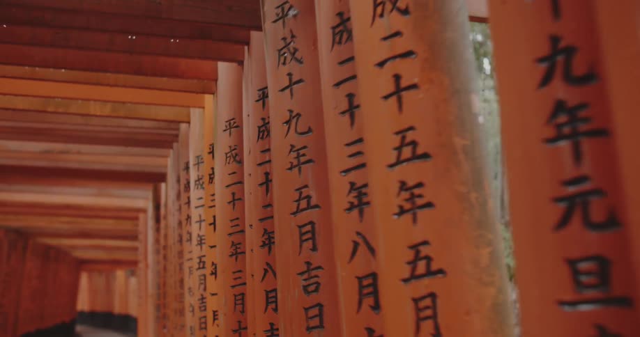 Columns with oriental characters line the tunnel
