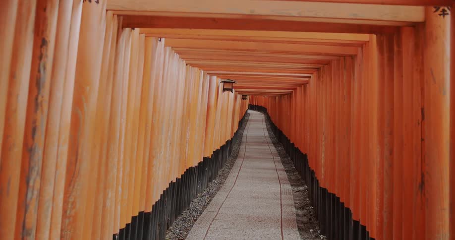 Long sidewalk inside a tunnel with lanterns