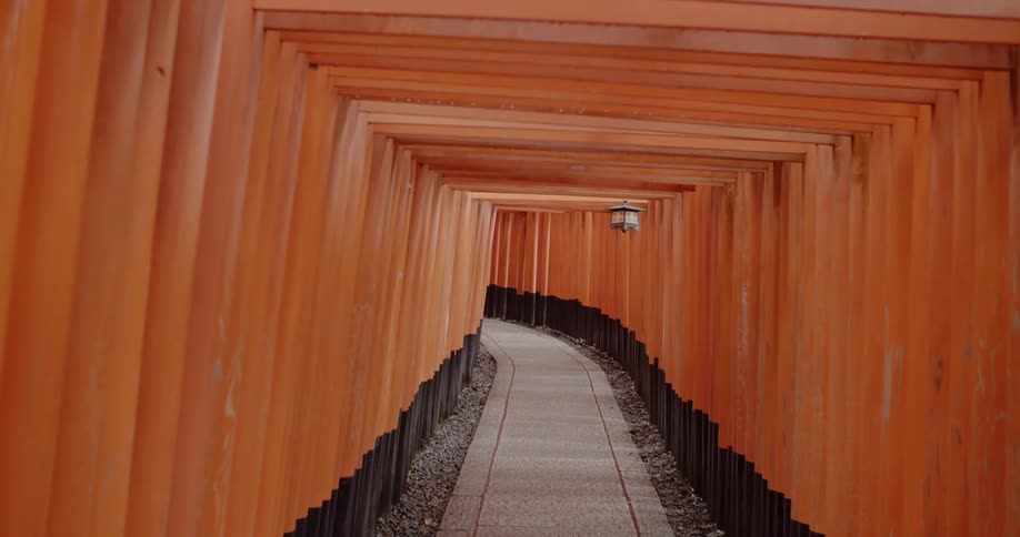 A lantern hangs in a red tunnel