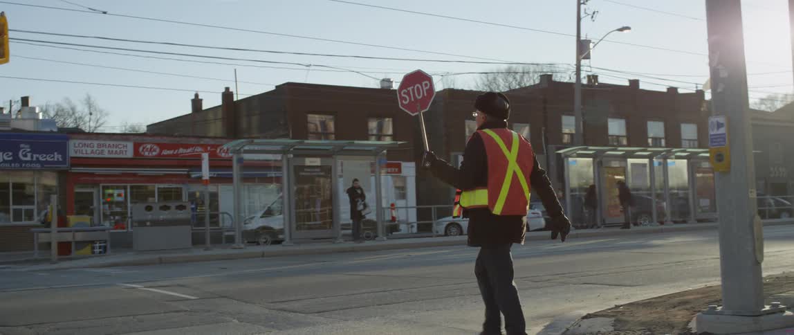 A crossing guard directs traffic