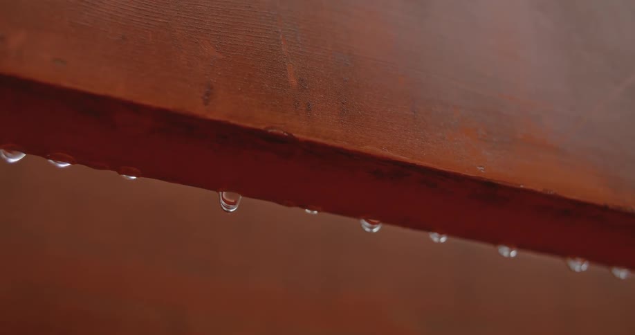 Water droplets hanging off a ledge