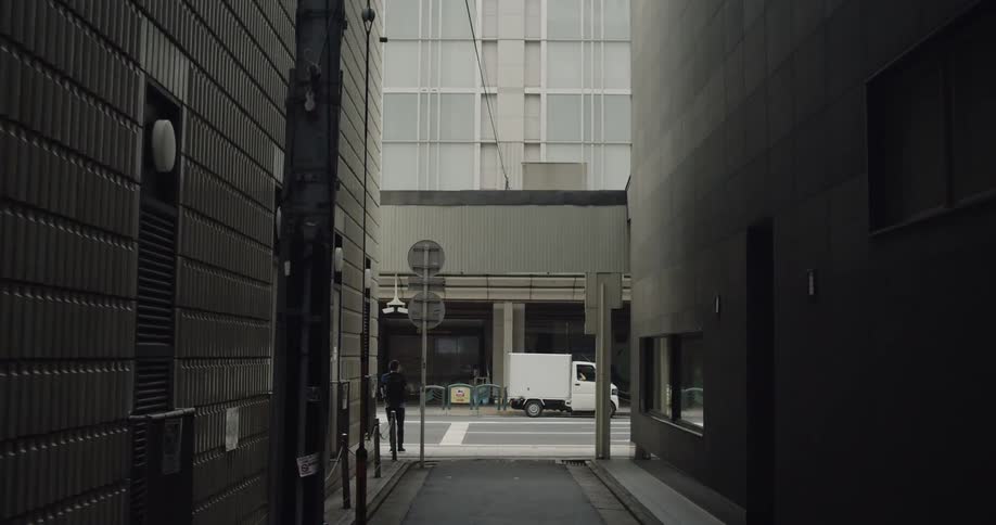 Cars drive on a city street