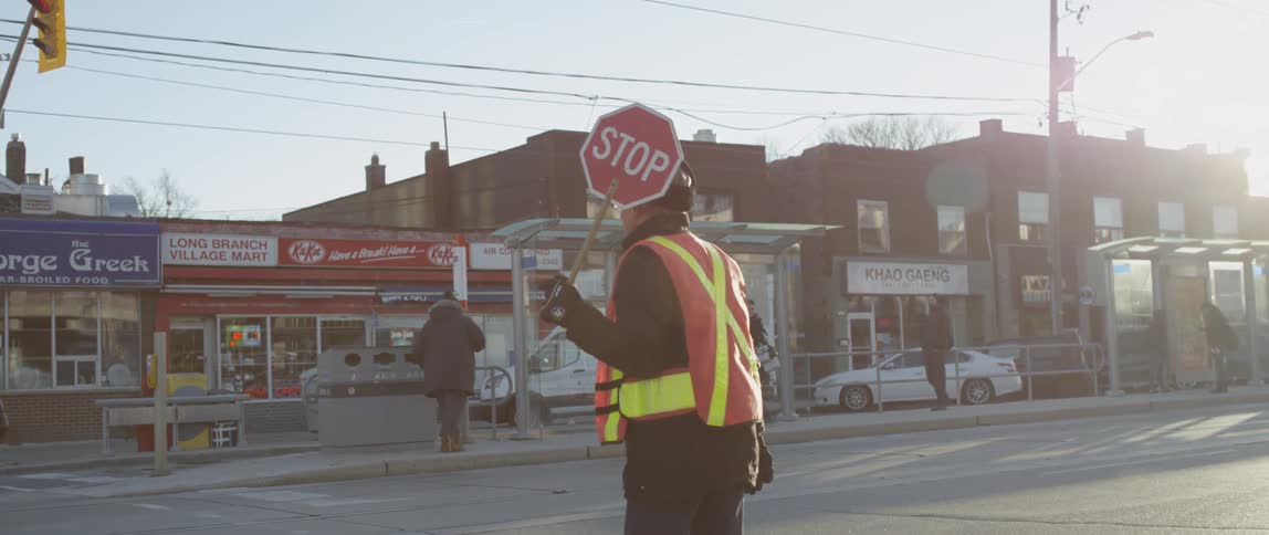 A crossing guard holds a stop sign