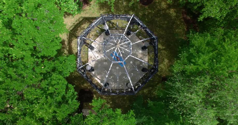 A gazebo stands surrounded by trees