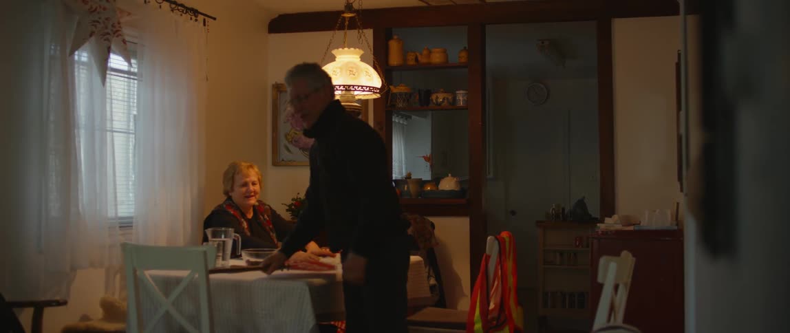 A woman laughs and celebrates while playing a game with her husband