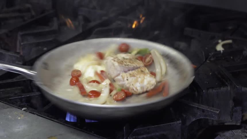 Fish is cooked in a pan