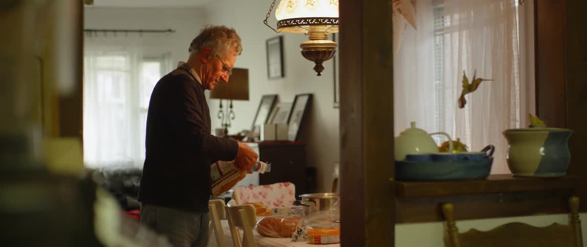 A man places bread onto the table