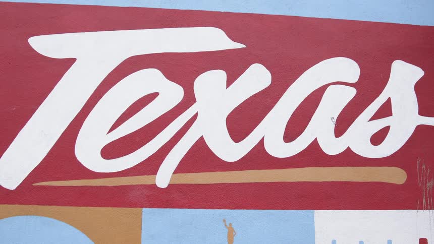 The word texas is painted on a wall