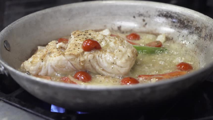 Fish is cooked in a pan