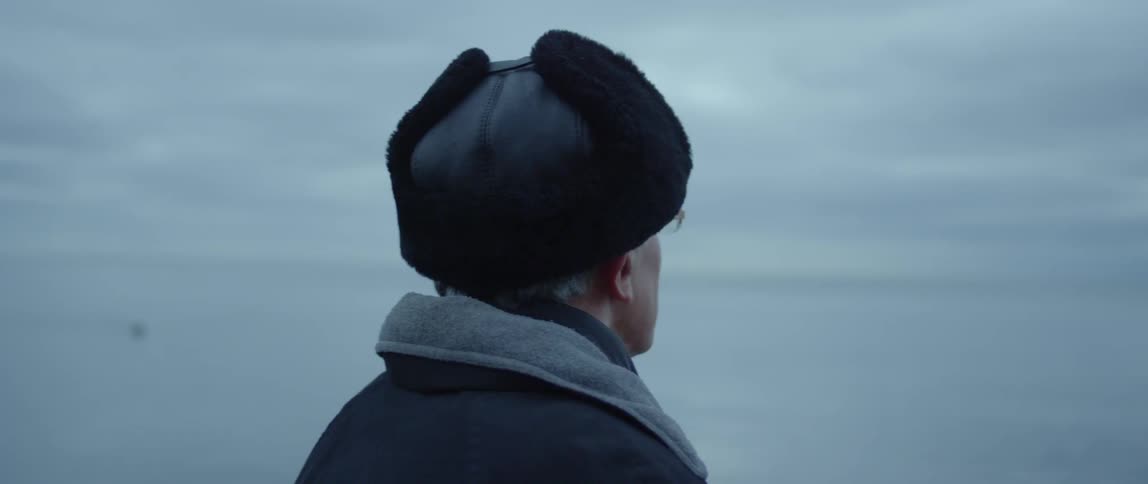 A man looks out onto the water