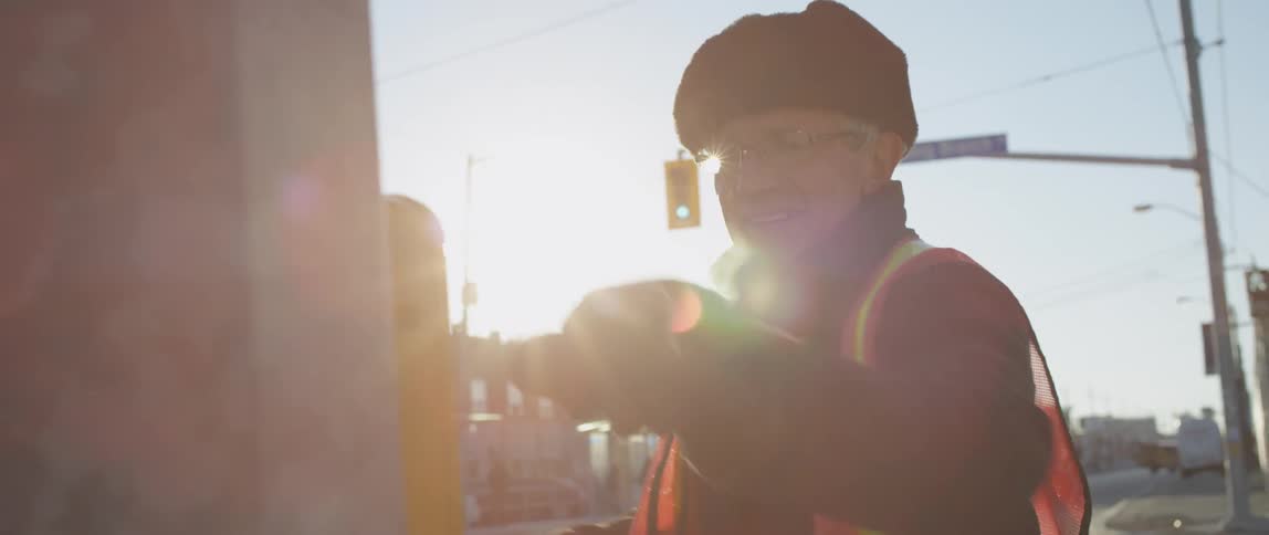 A crossing guard punches the air