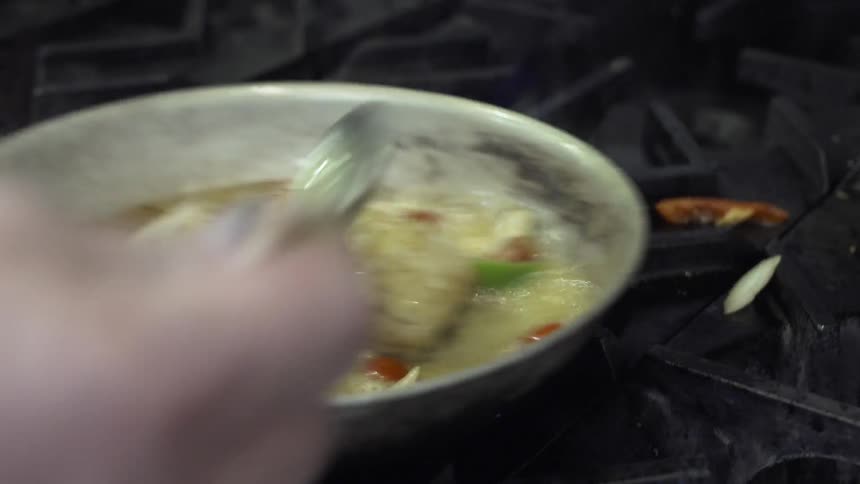 Fish and vegetables are seared in a pan