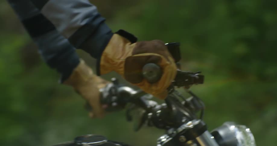 A man stands up while riding the motorcycle