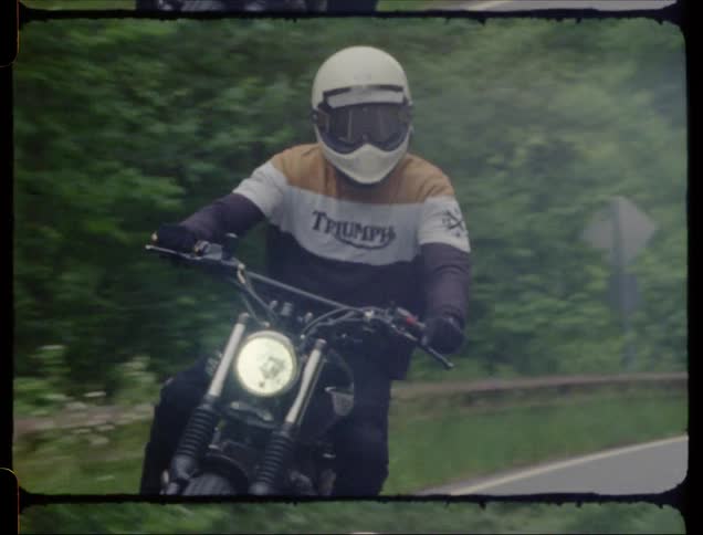 A motorcyclist rides in a forest