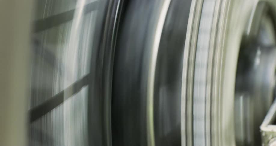 A motorcycle tire splashes water while rotating